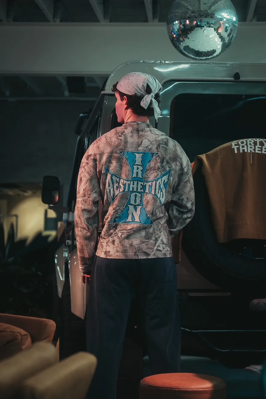 The Blue Cross Long Sleeve, worn beside a truck under a disco ball
