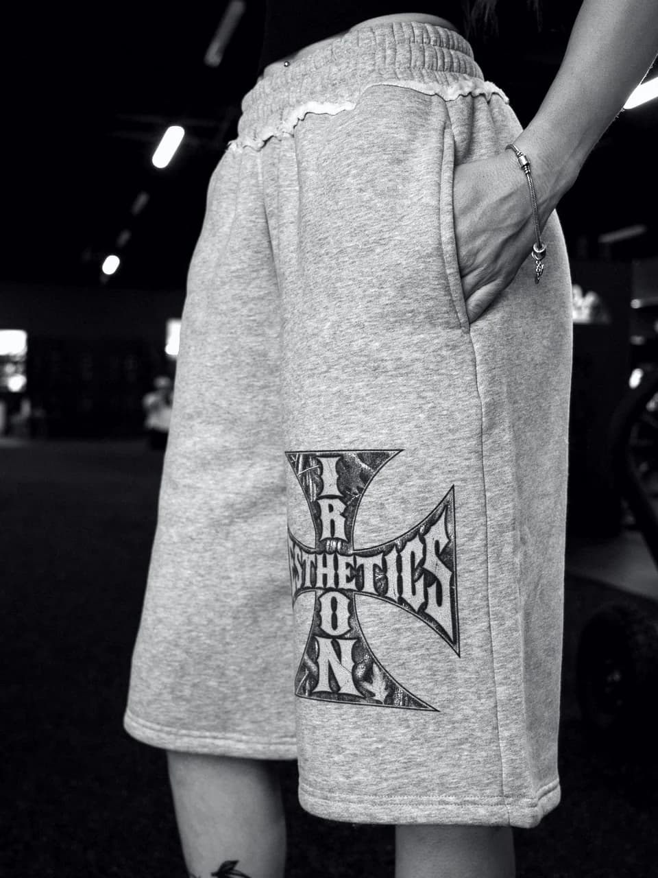 The Raw Edge Fleece Shorts in heather grey, worn in the gym