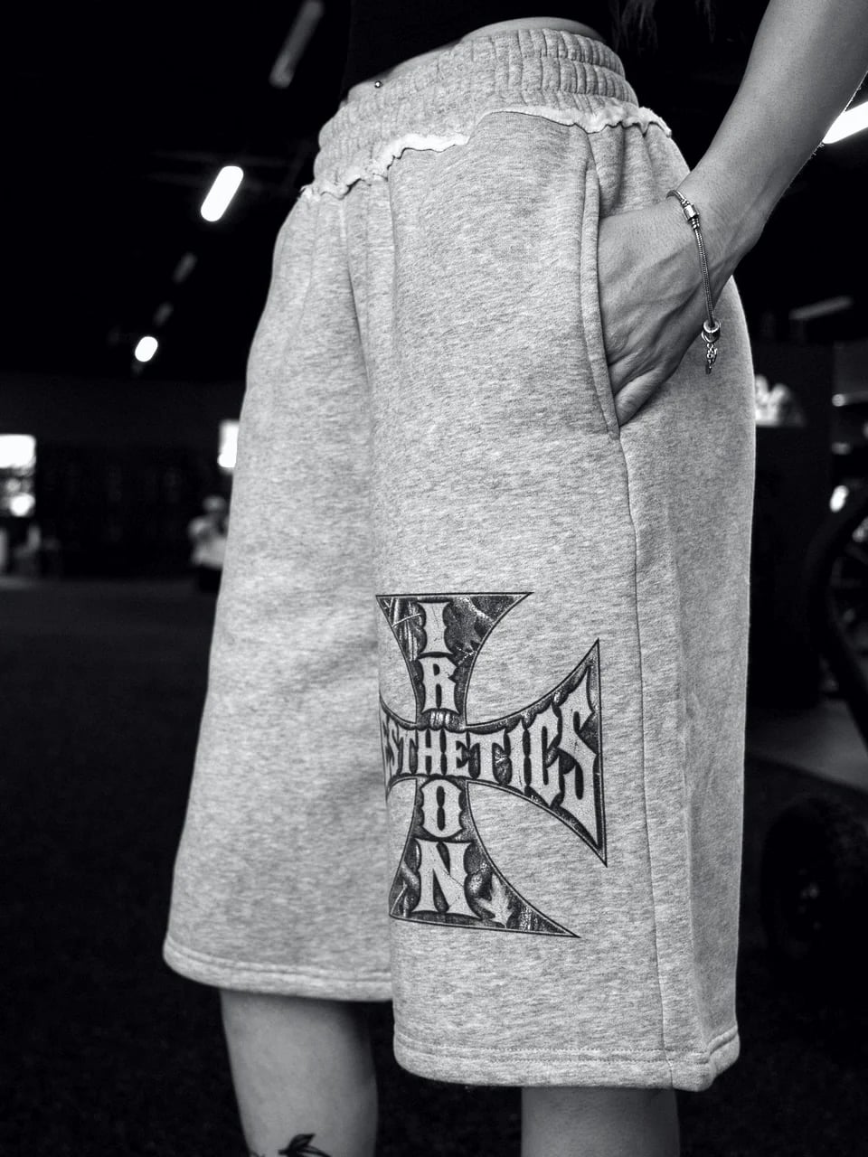 The Raw Edge Fleece Shorts in heather grey, worn in the gym