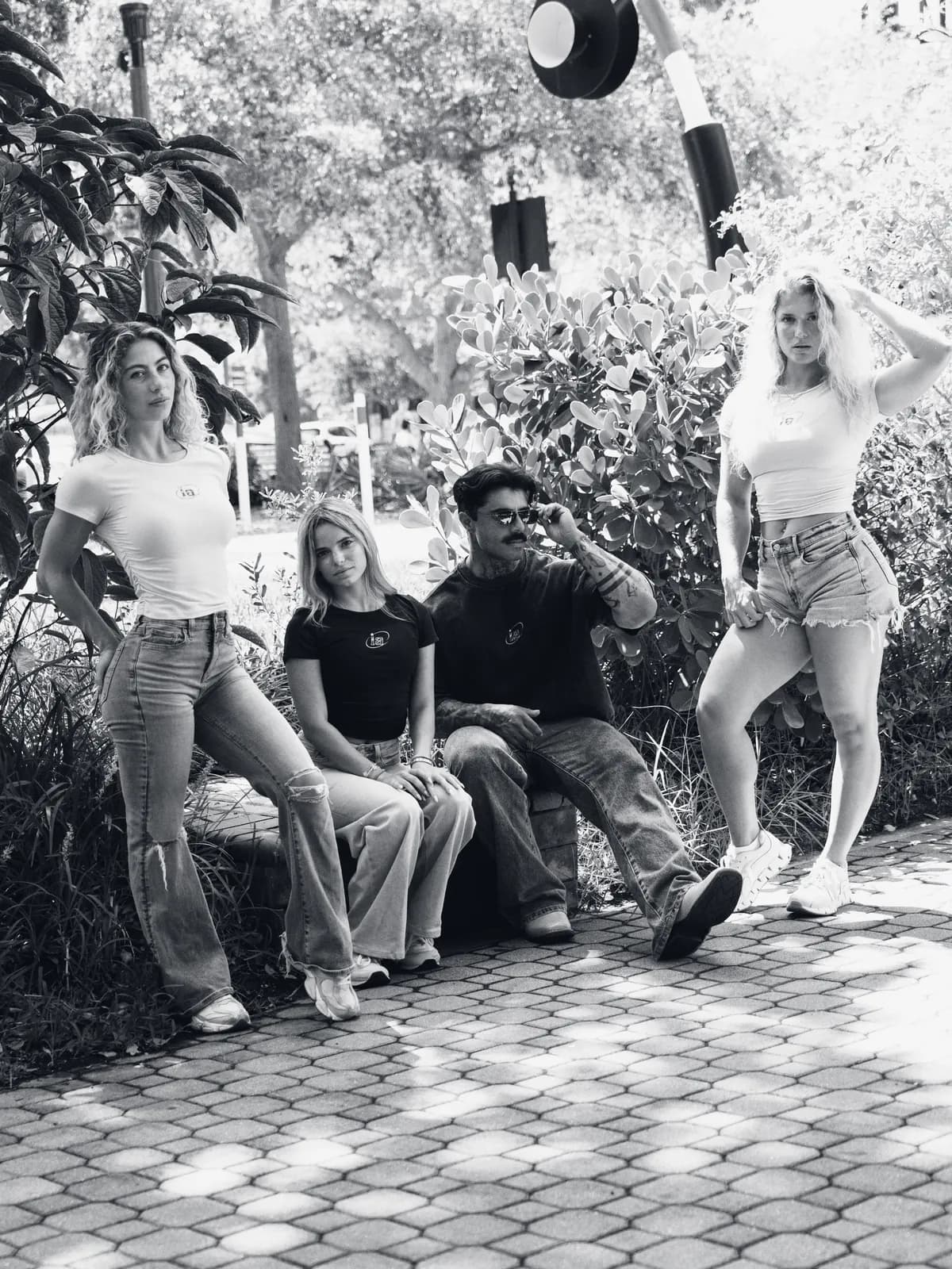 Four Iron Aesthetics athletes together on a park bench