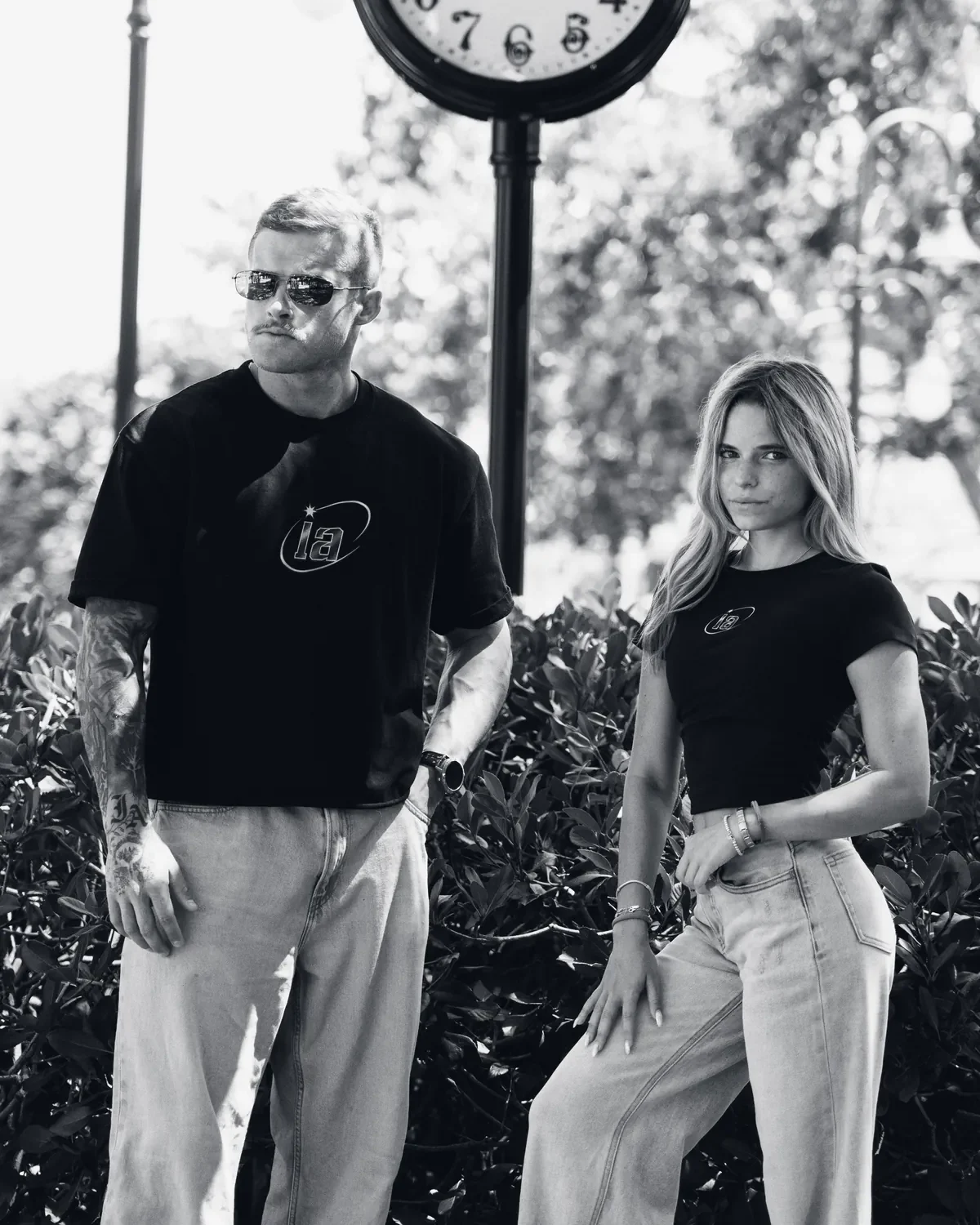 Two athletes in the black ia tee and crop tee